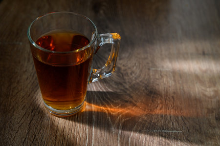 Glass cup of tea on a wooden table.の写真素材