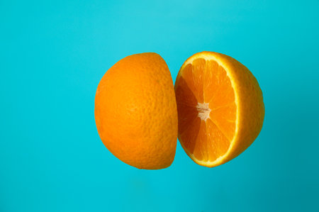 knife orange cuts on blue backgroundの写真素材