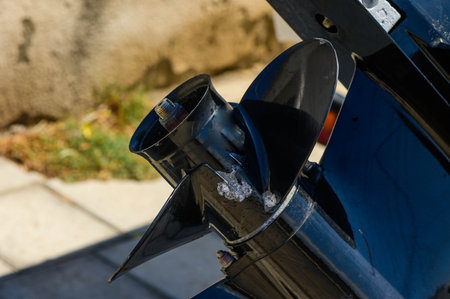 The propeller of a motorboat that is parked near the house