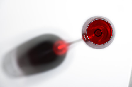 Shadow from a glass with red wine on a background.の写真素材