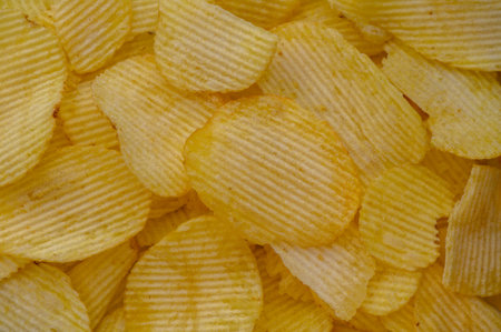 A stack of potato chips, a popular junk food, placedの写真素材