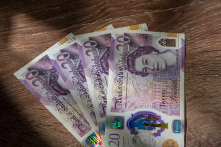 Currency banknotes spread across frame british pound sterling in various denominationの写真素材