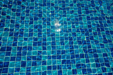 Blue water surface viewed from above in outdoor pool, sun reflection, brightly. Surface Abstract Background.の写真素材