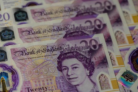 20 British pounds bills lies isolated on white background with copy space stacked in fan close upの写真素材