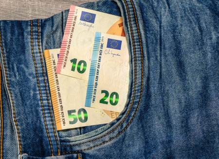euro bill in the pocket of jeansの写真素材