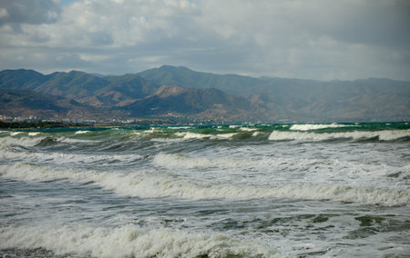 sea, clouds, mountains and waves on the Mediterranean coast on the island of Cyprus at sunset