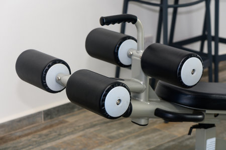 This setting features a piece of versatile gym equipment designed for lower body exercises,...