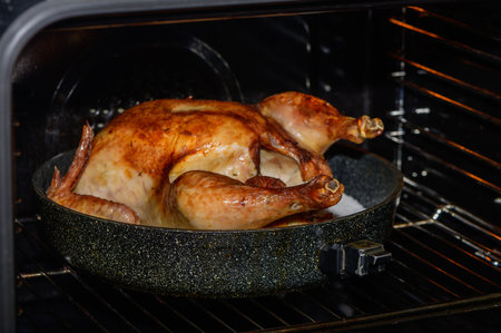 A delicious turkey bakes in the oven, creating a warm, inviting atmosphere perfect for holiday gatherings.の写真素材