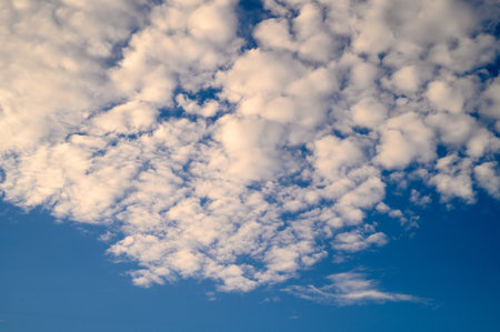 The sky is adorned with soft, cotton-like clouds, creating a peaceful atmosphere above.