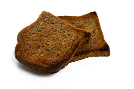 Two perfectly toasted slices of whole grain bread sit invitingly, ready to be enjoyed with spreads...