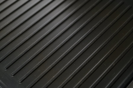 Textured grill surface awaits delicious food, offering a glimpse into culinary creativity and summer cookouts.の写真素材