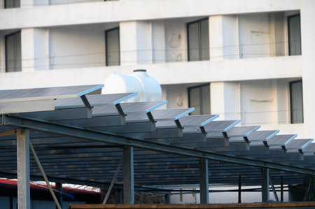 Solar panels line a structure, harnessing energy under bright conditions amid contemporary buildings...