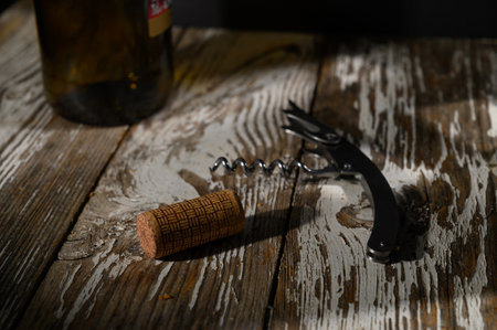 A corkscrew rests beside an uncorked bottle, inviting moments of relaxation and enjoyment with...
