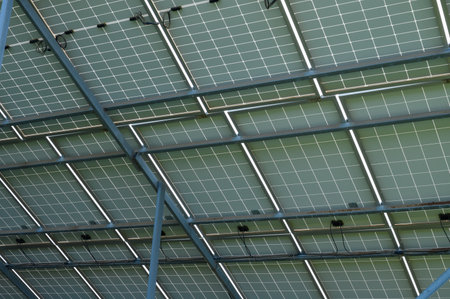 Energy-efficient solar panels capture sunlight, showcasing green technology on a contemporary...