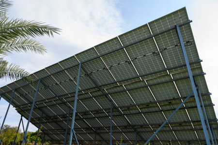 Solar panels stand tall against the sky, showcasing sustainable energy solutions in a lush, green...