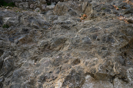 Explore the remarkable textures and patterns of ancient rocks in a rugged landscape, steeped in...