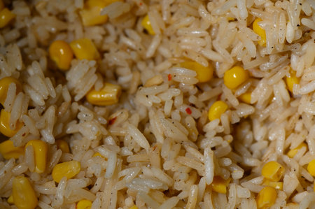 Delicious rice intermingled with sweet yellow corn, showing a comforting blend of flavor perfect for any occasion.の写真素材