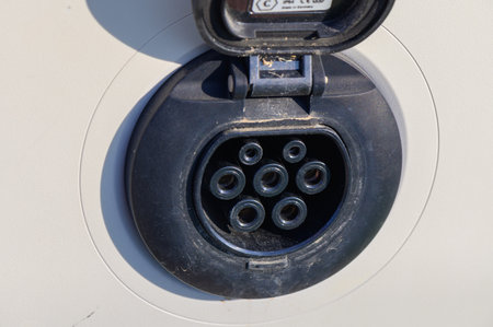 EV charging station with cable connected to an electric vehicle. Clean energy and modern...