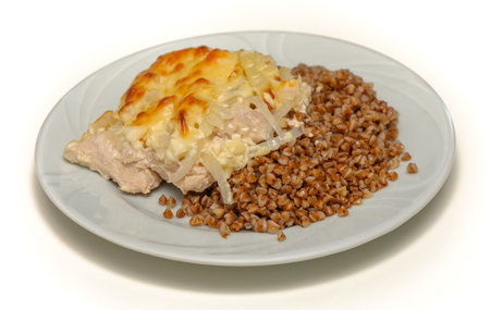 Buckwheat porridge with roasted meat on white backgroundの写真素材