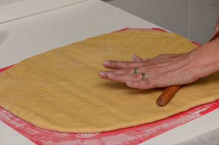 Traditional Dough Rolling by Hand for Homemade Pastries in Cyprus Kitchenの写真素材