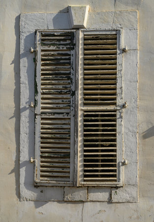 White Window with Wooden Shutters on Traditional Cyprus Houseの写真素材