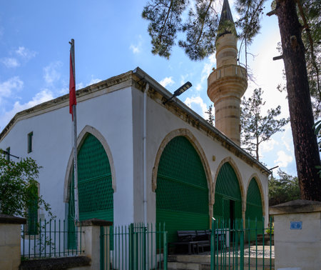Traditional old mosque with minaret in Lefke, Cyprus, surrounded by authentic Mediterranean architecture and a peaceful village atmosphere.の写真素材