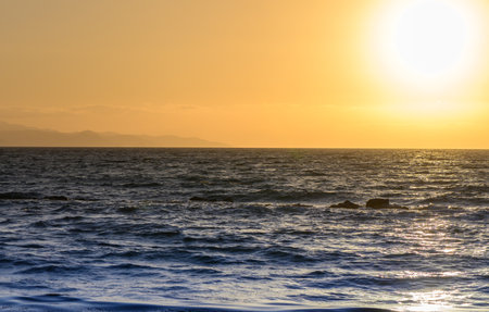 Golden Sunset Reflections on the Cyprus Shorelineの写真素材