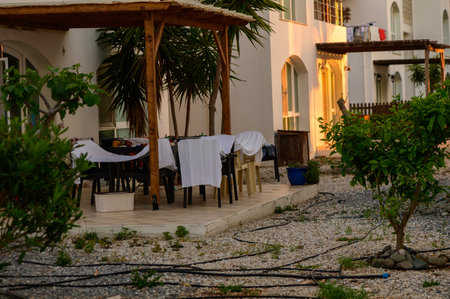 Freshly washed clothes drying on terrace chairs in a sunny Cypriot yardの写真素材