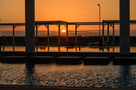 Golden Sunset Reflected in Pool Water at Mediterranean Resortの写真素材