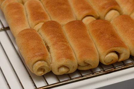 Golden Parker House Rolls Resting on Wire Rack After Bakingの写真素材