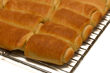 Fresh Parker House Rolls Cooling on Wire Rack at Homeの写真素材