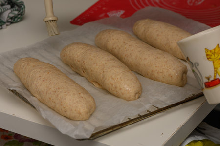 Applying Egg Wash to Homemade Graham Bread Loavesの写真素材