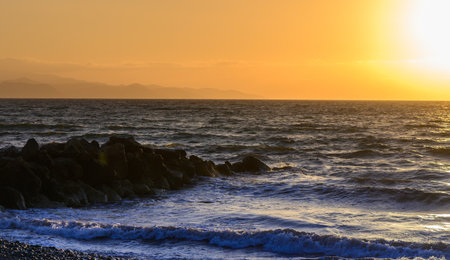 Golden sunset over the calm waters of the Mediterranean Sea in Cyprus.の写真素材