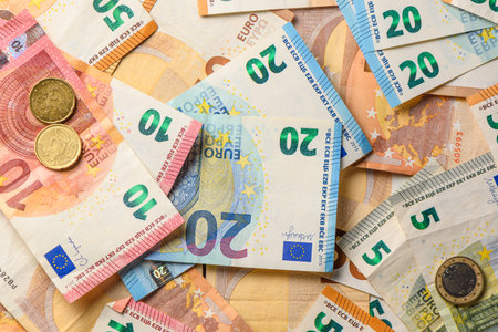 Close-up of mixed euro banknotes spread on table, representing European money, wealth, and economic...