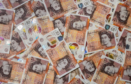 Close macro view of British ten pound sterling banknotes, representing financial success and UK currency background.の写真素材