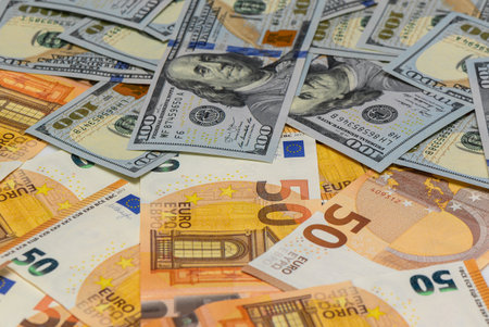 Close-up of 100 US dollar bills mixed with 50 euro notes, symbol of forex trading, international...
