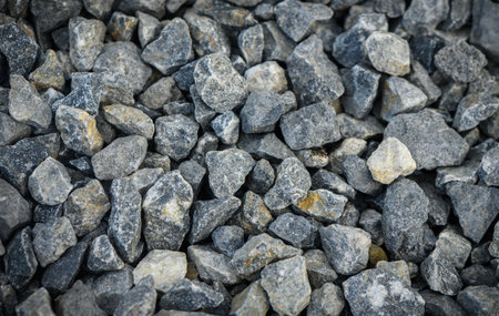 Macro photograph of fine granite gravel showing rough and granular texture. Ideal for design,...