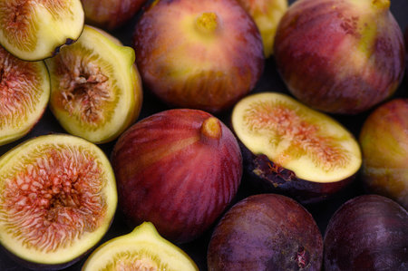 Close-up of ripe, juicy purple figs, creating a vibrant and textured background ideal for food,...