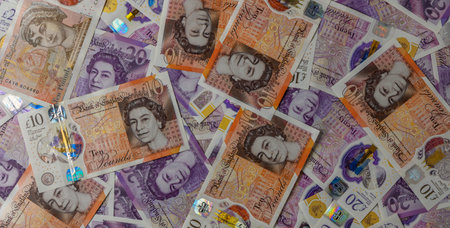 Closeup background of 10 and 20 British Pound Sterling banknotes, showing details and texture of UK currency for finance and economy concept.の写真素材