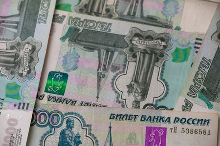 Closeup of Russian 1000 ruble notes scattered on a desk, creating a rich money background for...