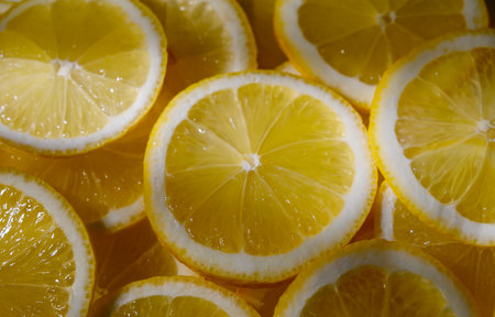 Fresh sliced lemons arranged as food background. Citrus fruit, concept of freshness, vitamins and...