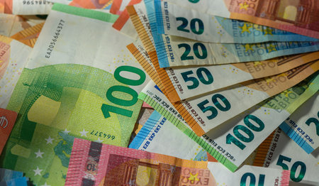 Colorful euro banknotes of different values form a bright money background.