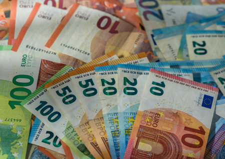 Scattered euro banknotes create a rich money background for financial themes.の写真素材
