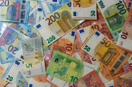 Colorful euro banknotes of different values arranged on table surface creating financial texture background.の写真素材