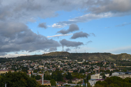 Evening Tbilisi with City Lights and Mountains