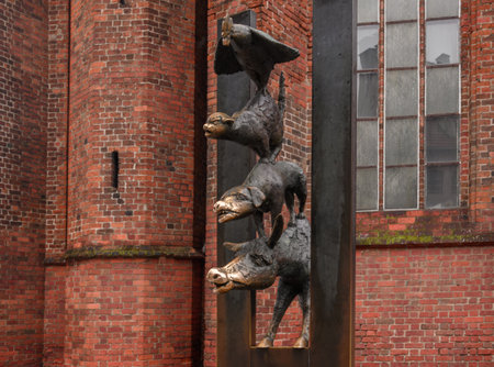 The sculpture of the Bremen Town Musicians stands on a street in Old Riga. Close-up and wide views showcase the artistic style of the monument and the historic city atmosphere.の写真素材