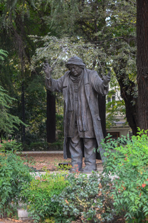 Bronze sculpture of actor Ramaz Chkhikvadze in Tbilisi, realistic monument surrounded by greenery, popular landmark for tourists.の写真素材
