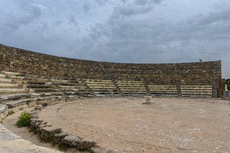 Amphitheater of the ancient city of Salamis in Northern Cyprus. Ruined stone seating, ancient columns, and remnants of walls under the open sky reflect the historical heritage of the site.の写真素材