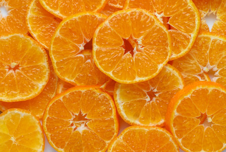 Close-up of appetizing sliced mandarins on a plate. Great as a background for food photography, macro shots, and culinary design.の写真素材