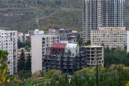 Panoramic hilltop perspective of Saburtalo district in Tbilisi with urban buildings, streets, and...